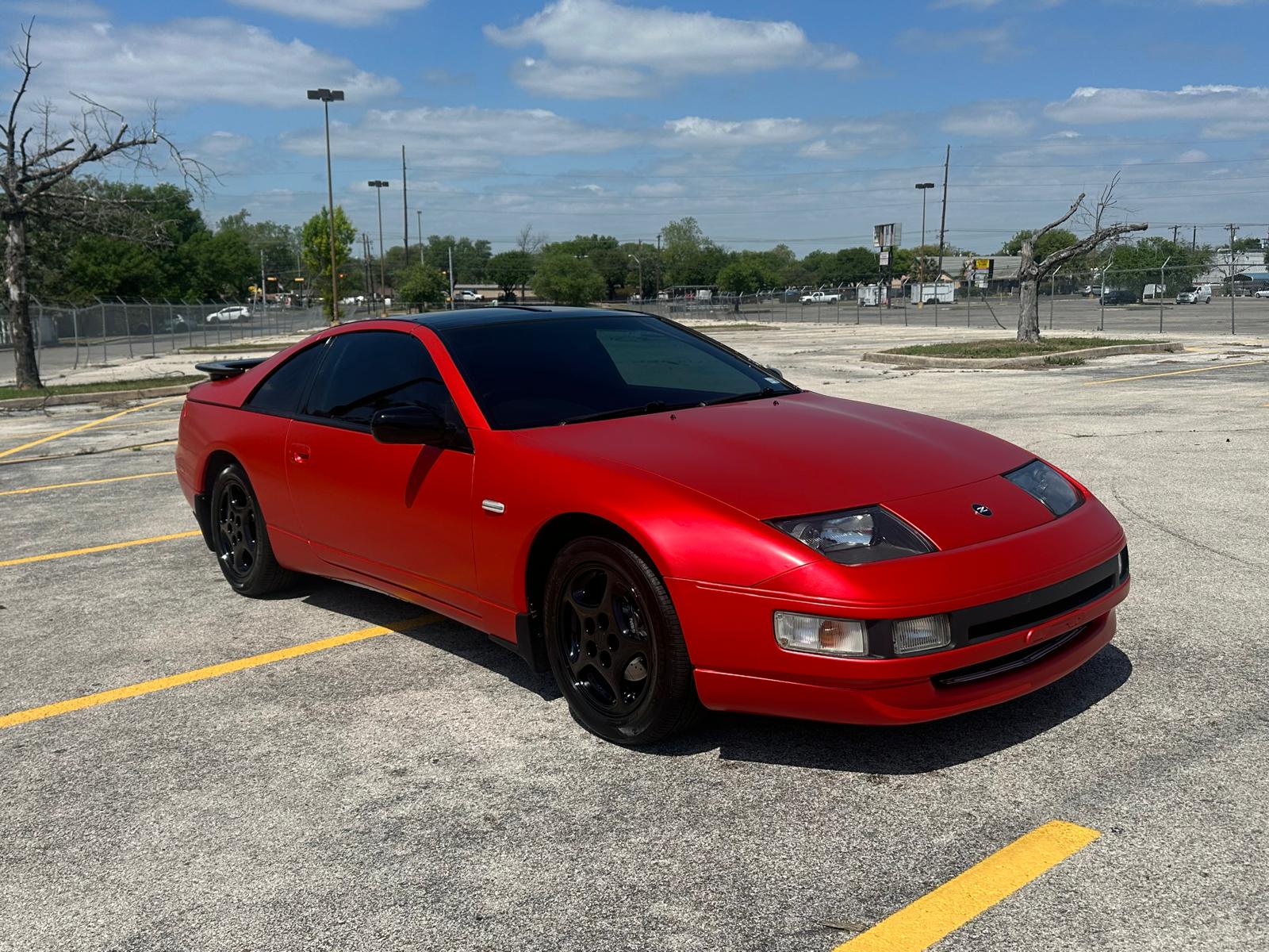 Red sports coupe front three-quarter view