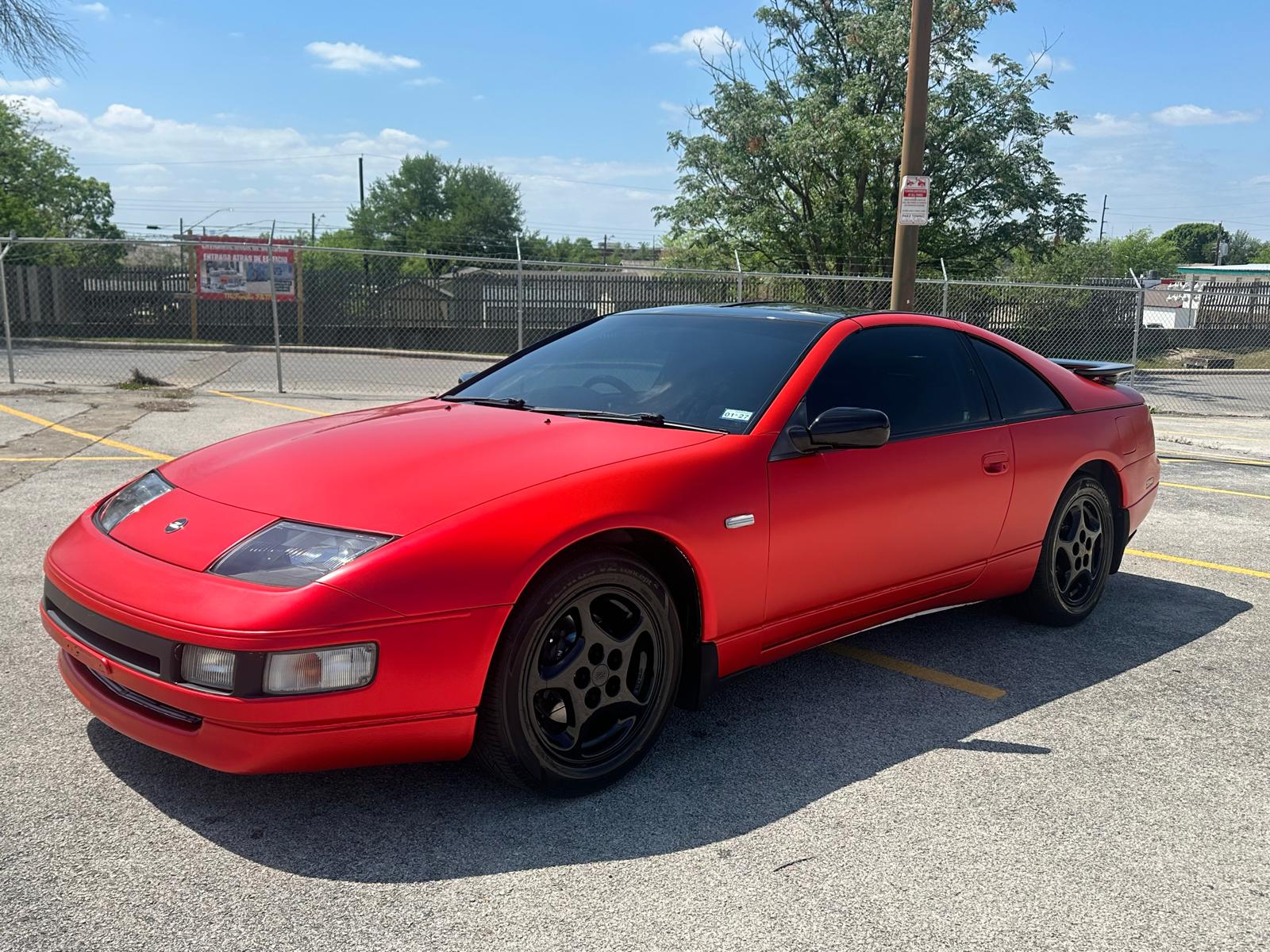 Red sports coupe alternate three-quarter view